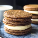 Ginger Molasses Sandwich Cookies with Eggnog Frostings